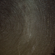 A long-exposure photo shows meteors in the context of stars’ movement.